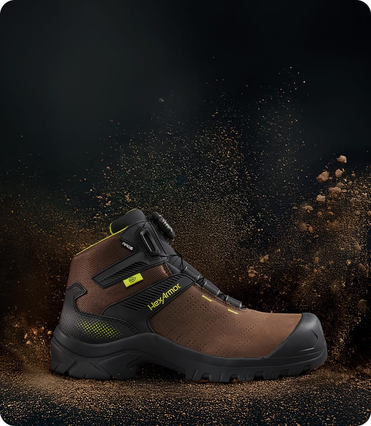 Profile of brown Xbase Boa safety boot with dirt flying repelling off boot